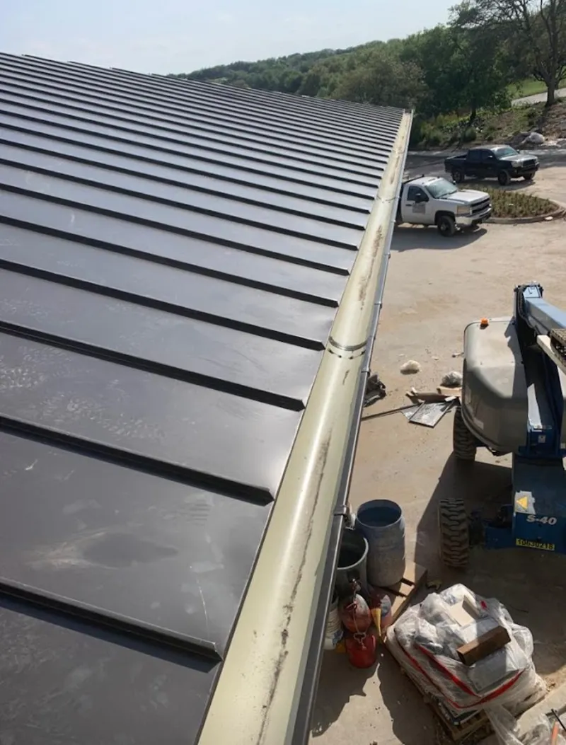 Standing seam panel and gutter detail on a metal roofing jobsite in Southgate